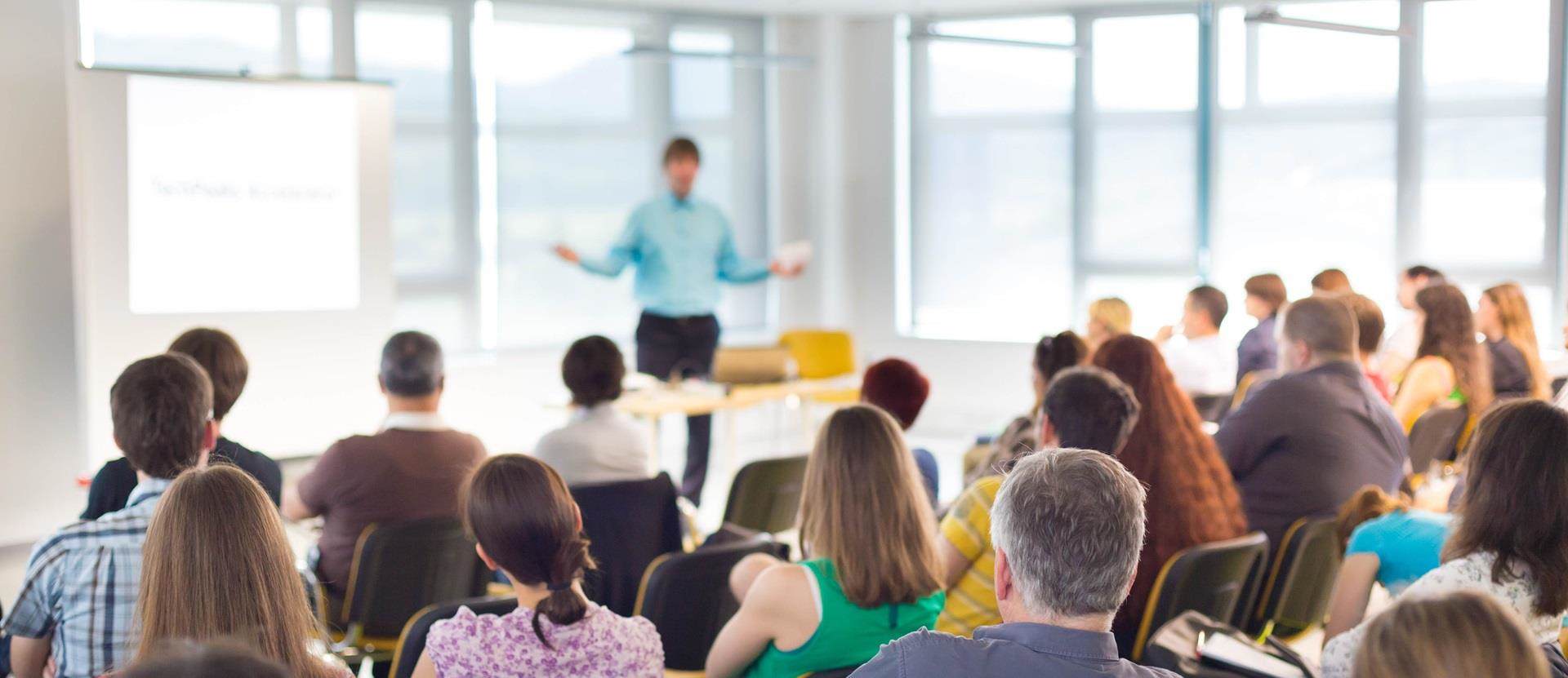 Speakers Giving a Talk at Business Meeting. Audience in the conference hall.