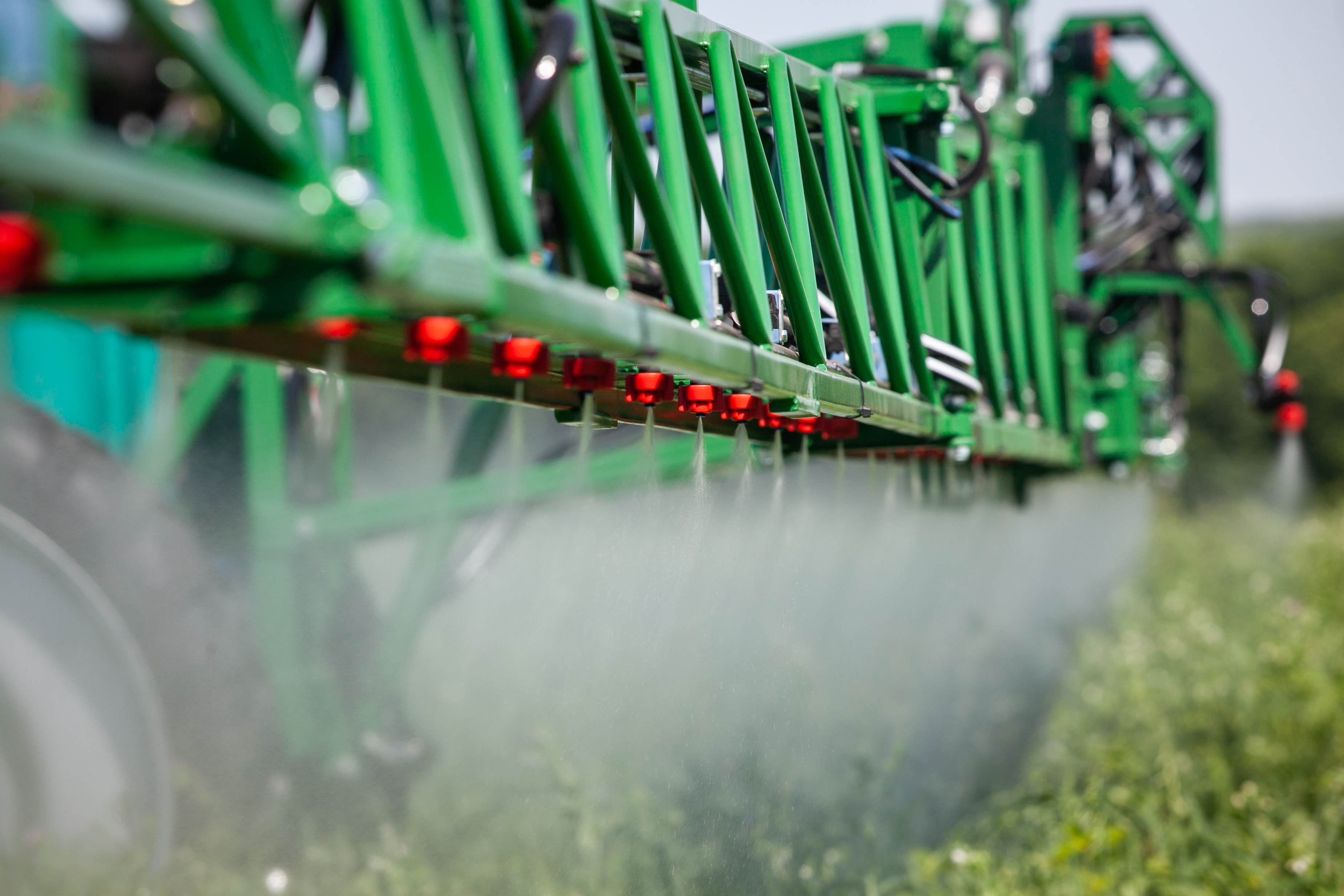 Agrochemical spraying arm over field
